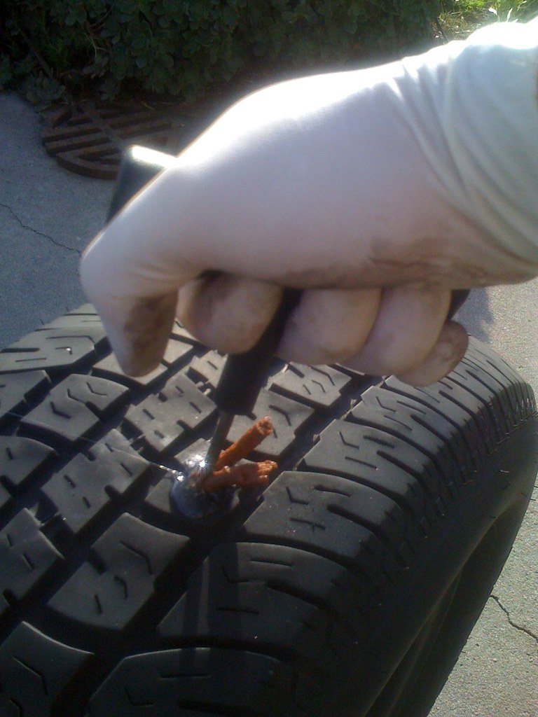 Puncture plug tool being inserted into a tyre tread